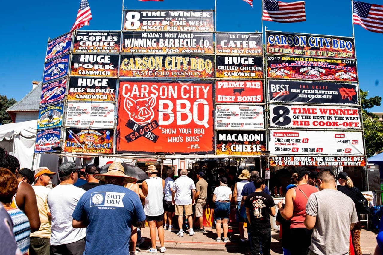 The Carson City BBQ cook-off booth facade, its stacked signs topped by an eight-time-winner banner