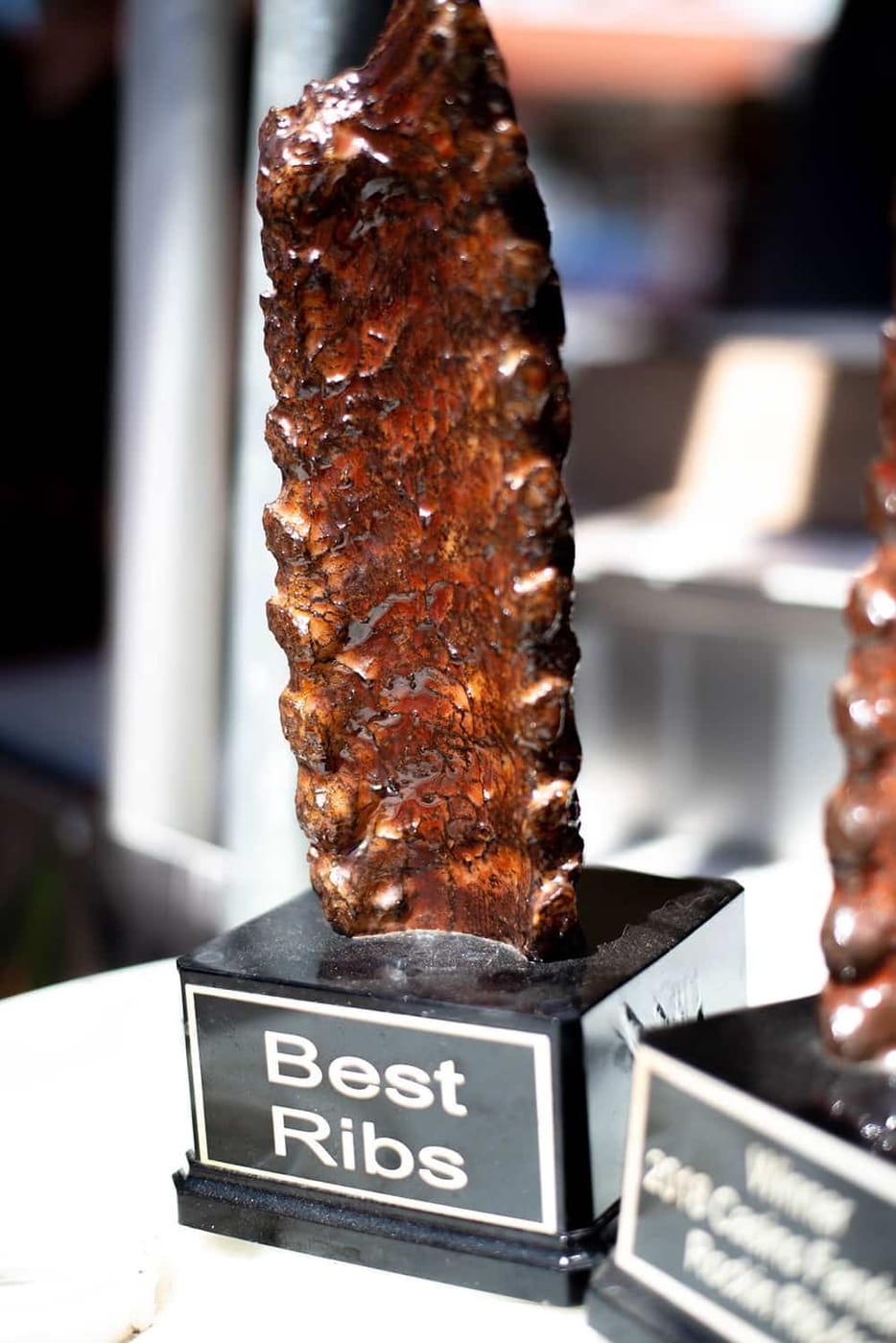 A trophy shaped like an upright rack of ribs cast in bronze, its base plate engraved "Best Ribs".